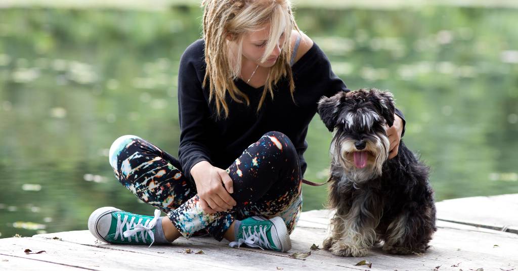girl and a dog at the lake